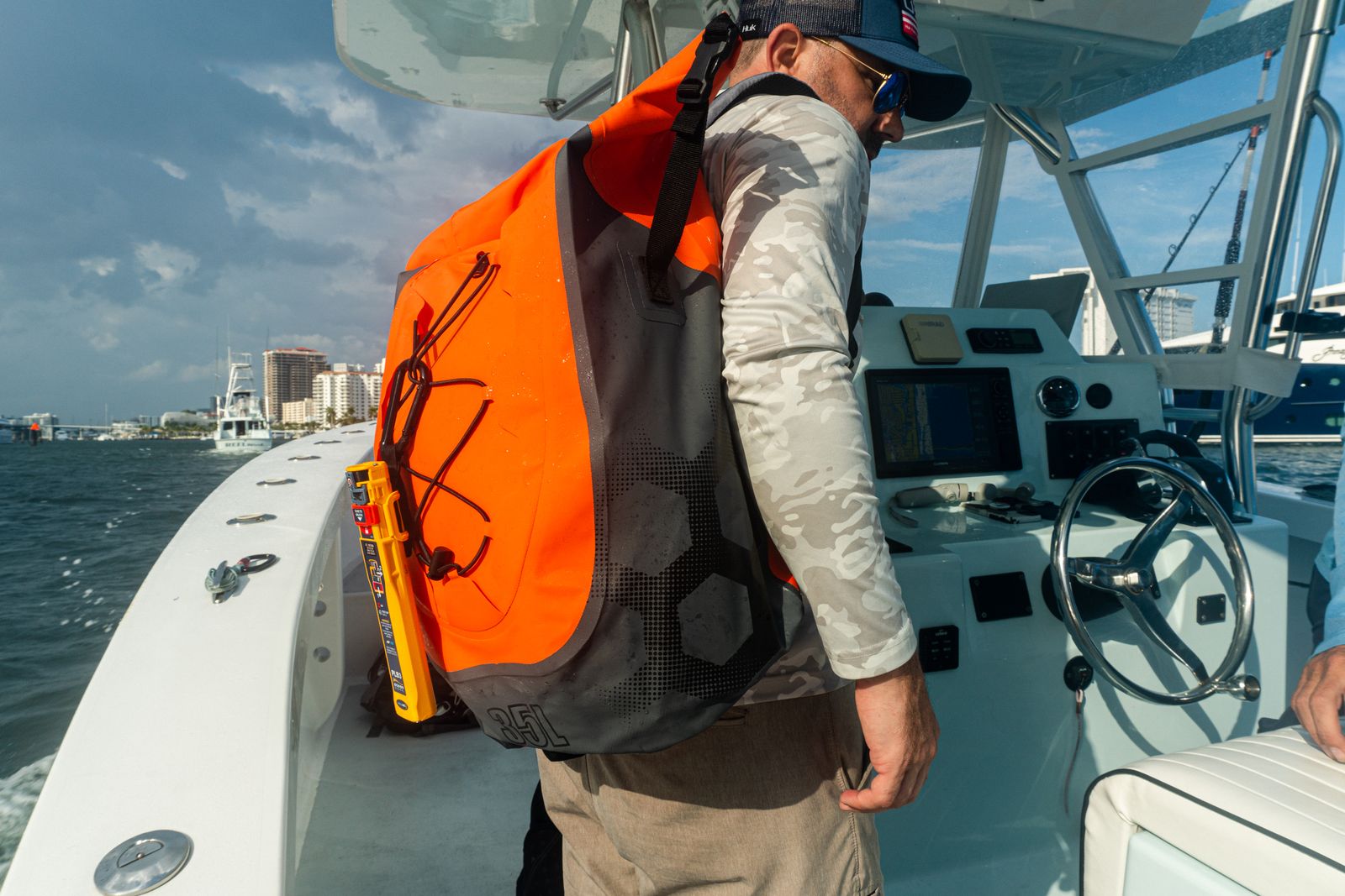 rescueME PLB3 secured to the webbing of an orange bag carried on board a boat