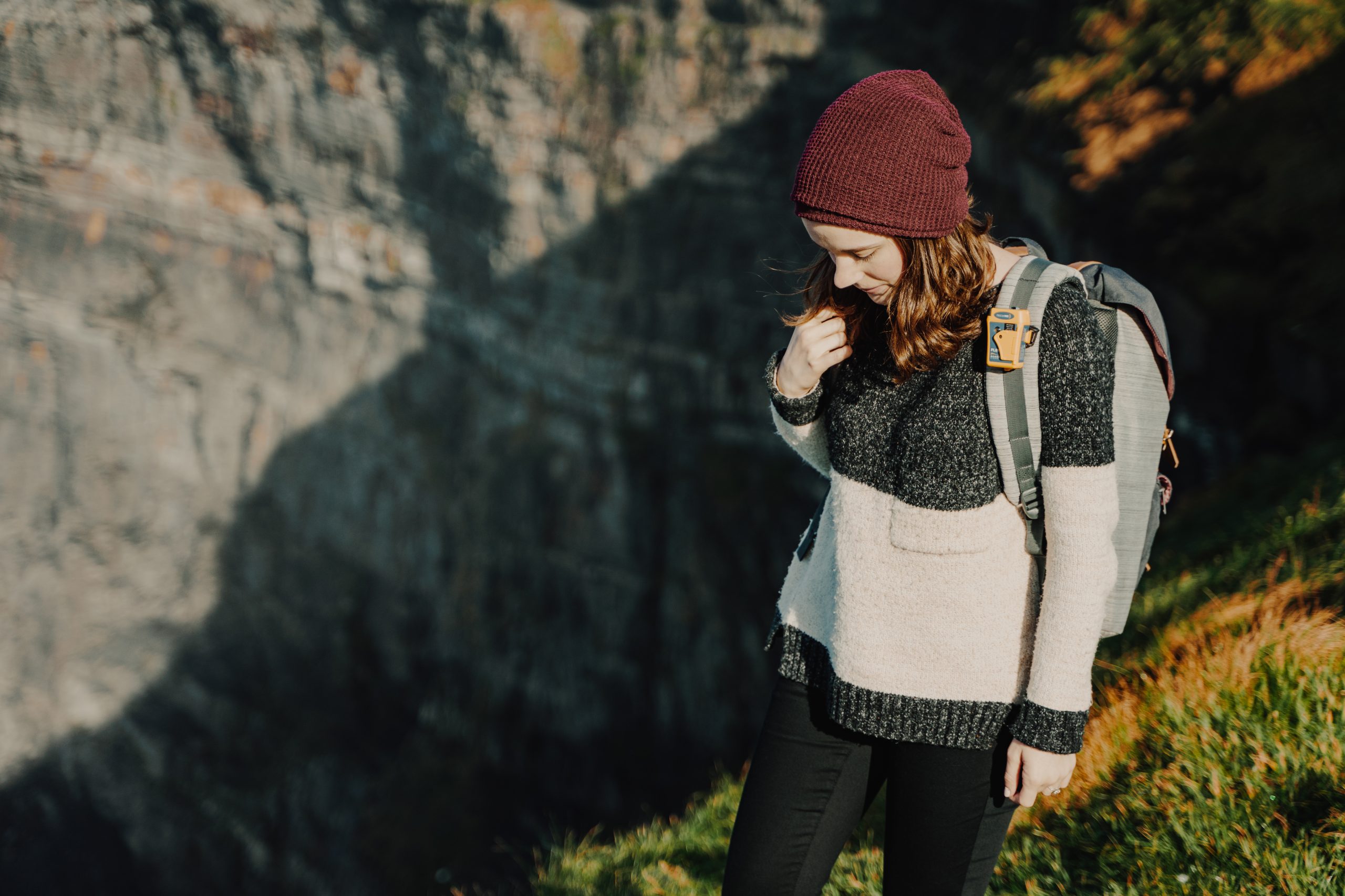Hiker wearing a rescueME PLB1 clipped to a backpack shoulder strap