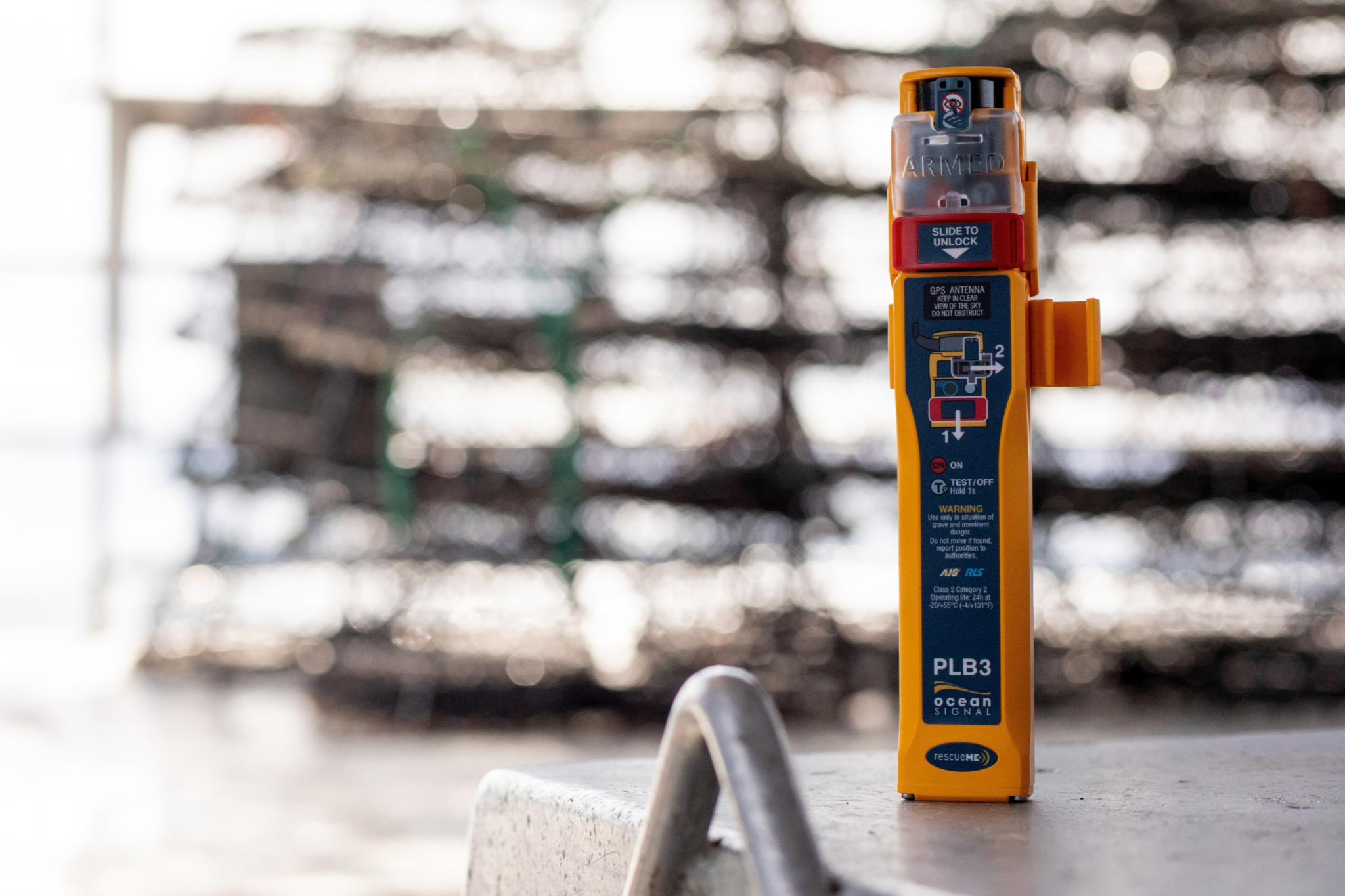 Ocean Signal rescueME PLB3 AIS personal locator beacon, front view by the water